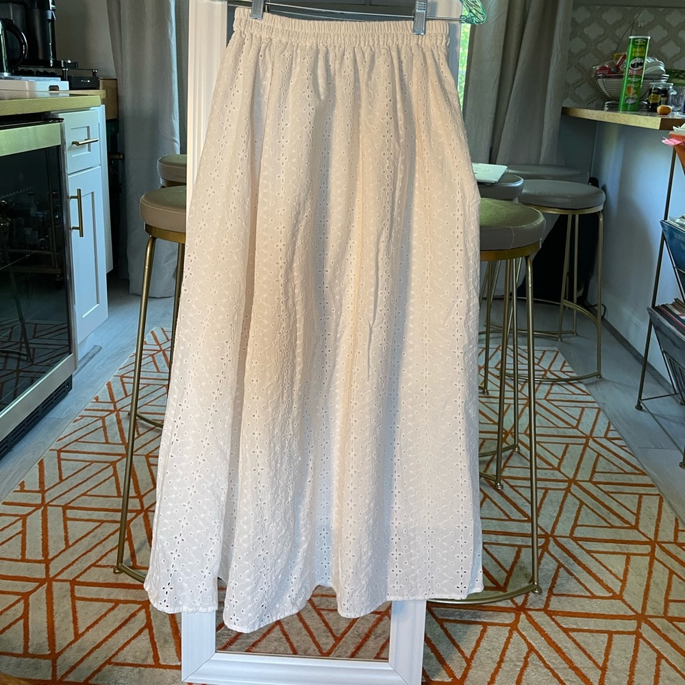 White lined skirt. Stretch elastic waist. Fits comfortably a size S/M.